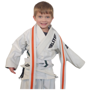 A young boy smiling proudly after earning his new belt in the Pre-K Martial Arts program at Next Generation Martial Arts Thibodaux.