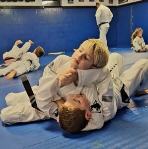  Two young boys practicing headlock defense in a youth martial arts class at Next Generation Martial Arts.