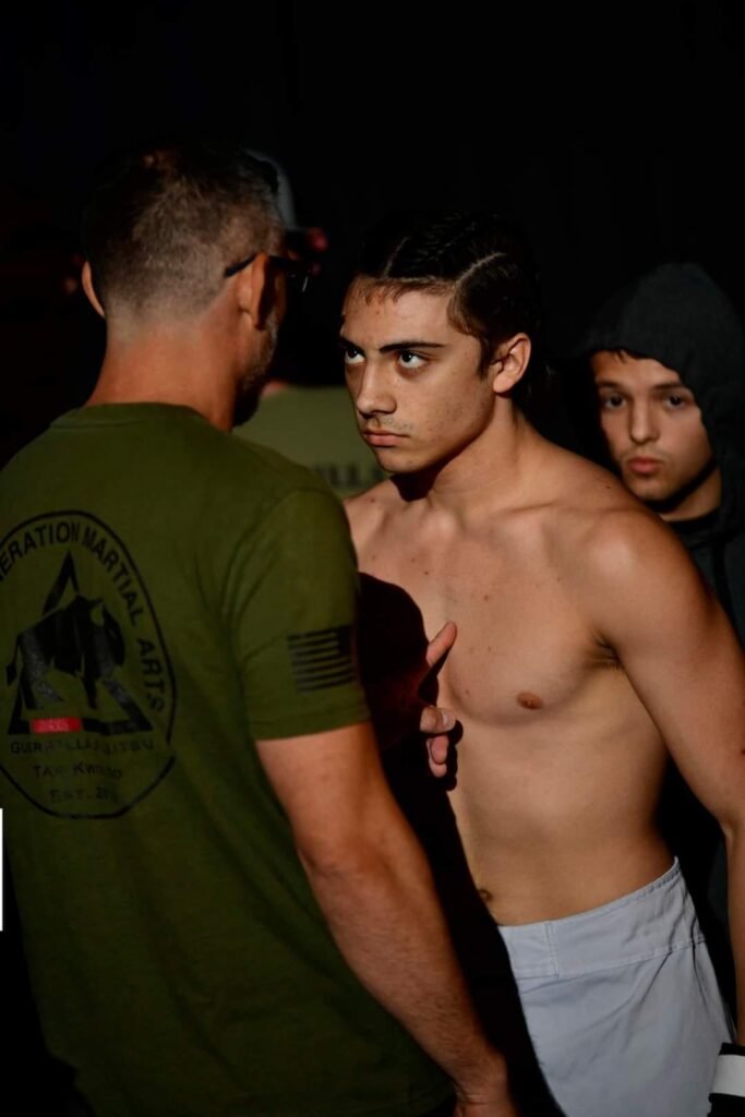 Scotty Smith Jr. giving last-minute advice to Ty Smith before an MMA fight in Thibodaux