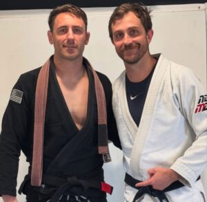 Shane Thibodaux, Brazilian Jiu Jitsu black belt instructor at Next Generation Martial Arts, standing confidently in a black gi.