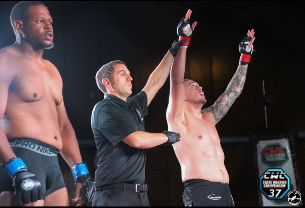 Joe Borkowski has his hand raised after winning his professional MMA debut, marking the start of his pro career in Louisiana.