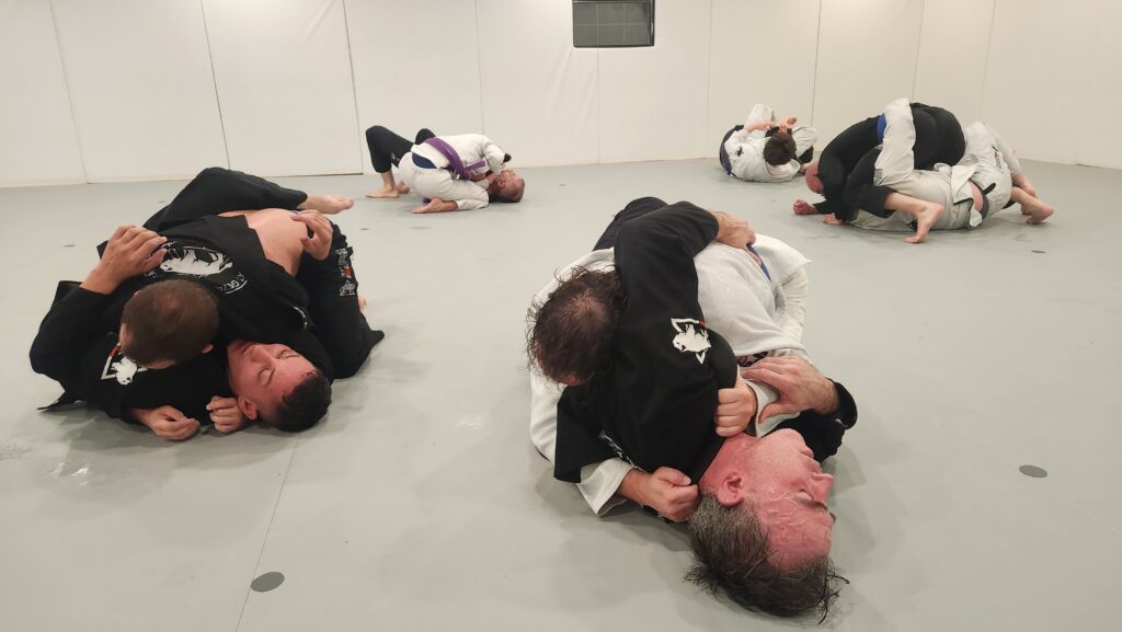Beginner adult student learning Brazilian Jiu Jitsu technique in Thibodaux