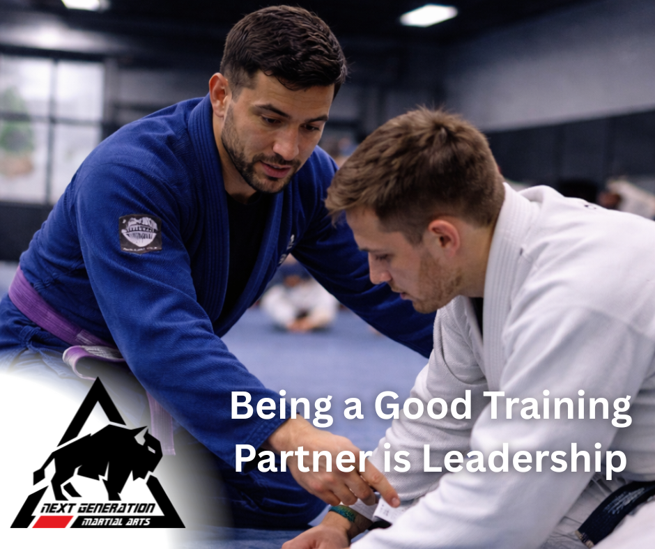 Being a good training partner in jiu jitsu as a purple belt guides a white belt through technique during class